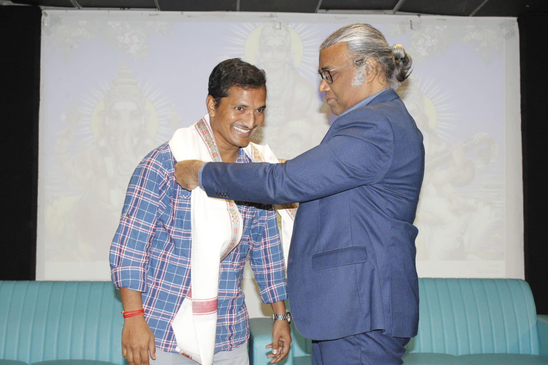 Navaneeth Reddy during the shawl presentation on stage