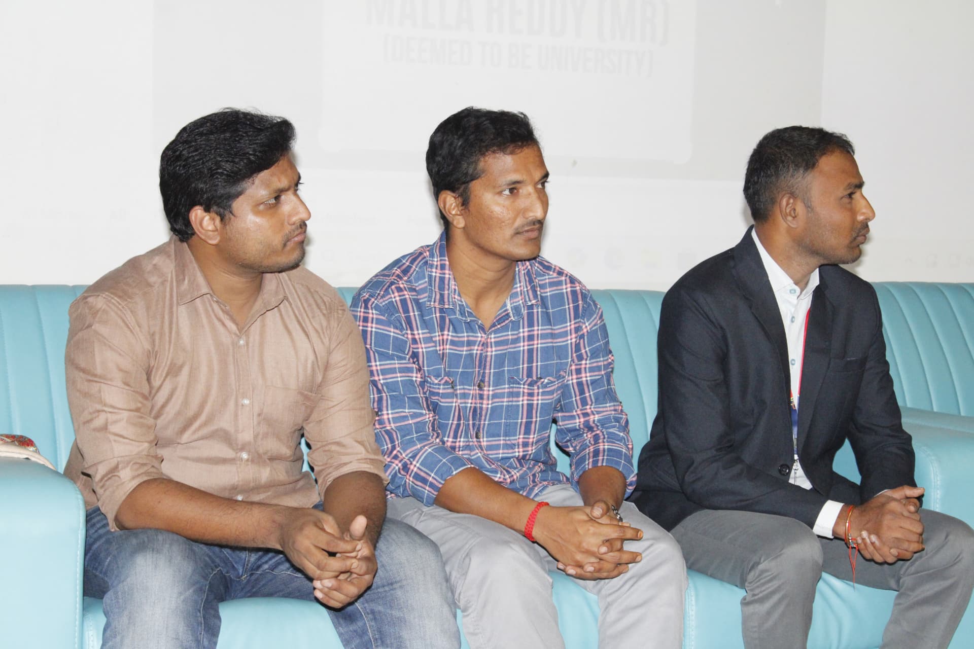 Navaneeth Reddy and Velamarthy Gopichand seated with an event attendee