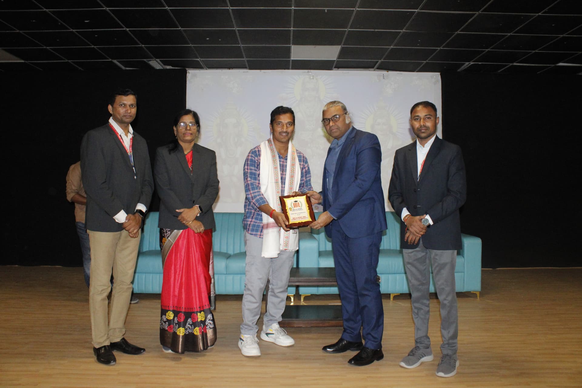 Navaneeth Reddy and attendees posing with a memento